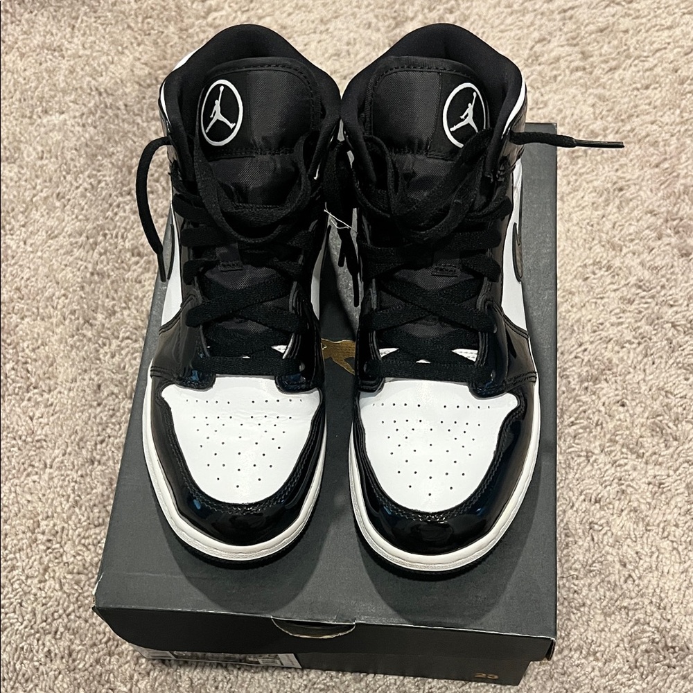 Air Jordan 1 Mid Black and White Patent Leather Sneakers. Grade School